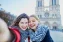 Two young women making a Selfie picture infront of Cathedral Notre Dame Paris France